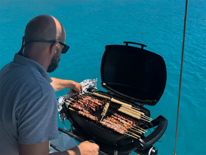 The captain of Aegeas is grilling the souvlaki